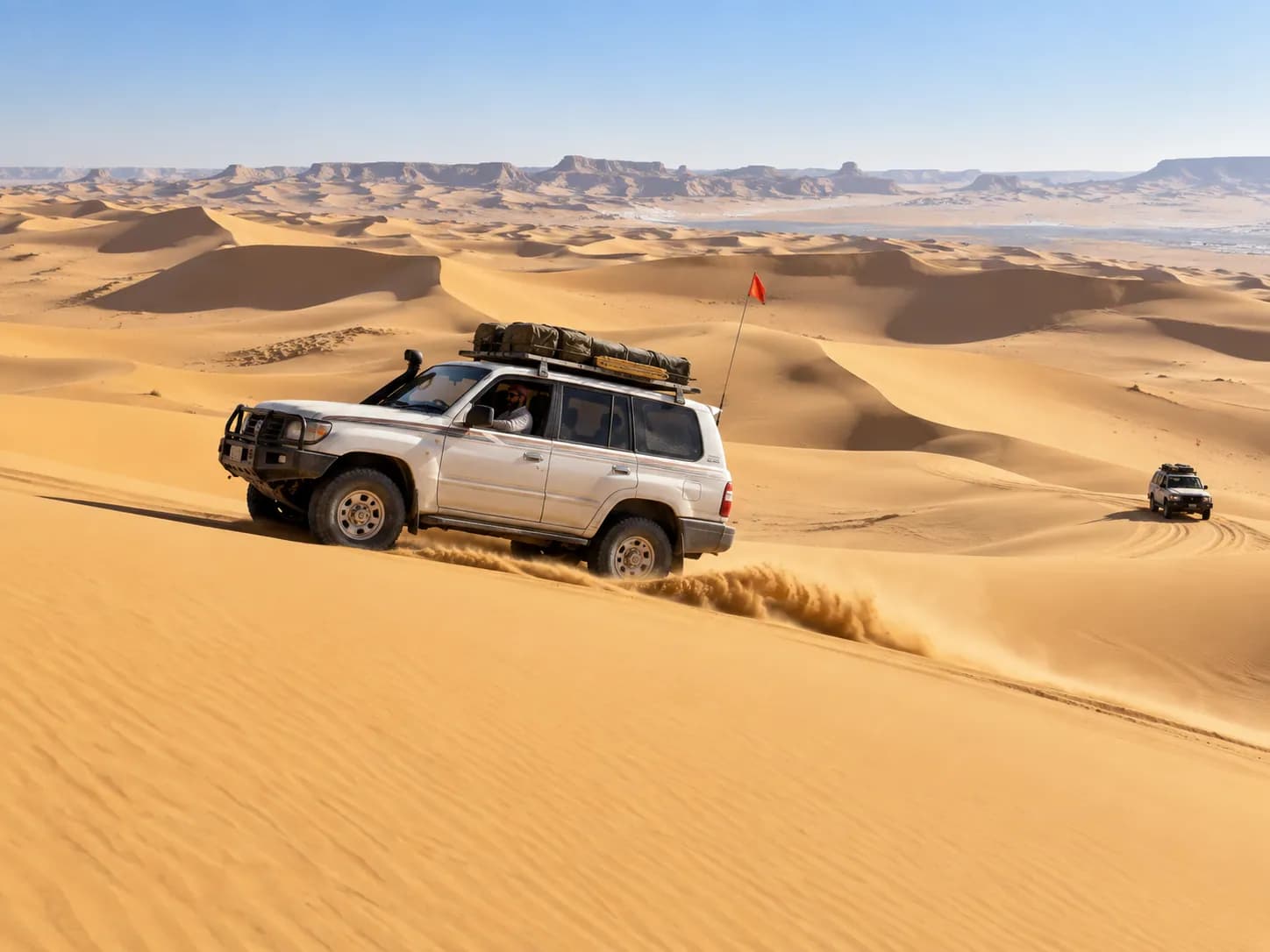 A 4×4 crossing the dunes of the Great Sand Sea